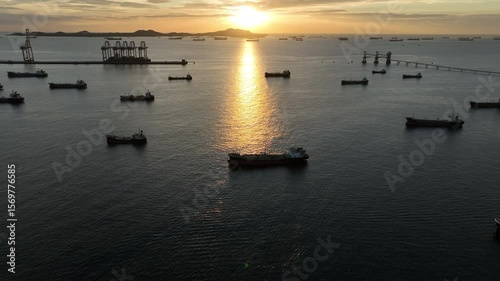 Aerial view oil tanker ship and gas tanker ship at sunset, Silhouette oil and gas tanker ship at oil and gas terminal, Global business import export logistic transportation oil and gas petroleum.