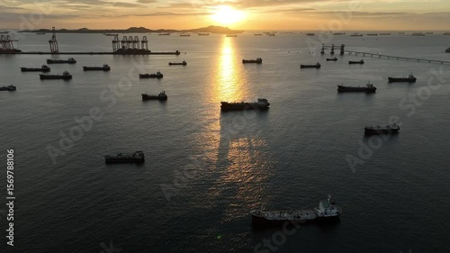 Aerial view oil tanker ship and gas tanker ship at sunset, Silhouette oil and gas tanker ship at oil and gas terminal, Global business import export logistic transportation oil and gas petroleum.
