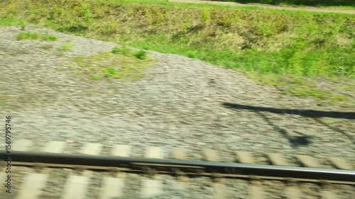 Rails and sleepers, side view when moving from a passing train. Travelers see railway tracks rushing past