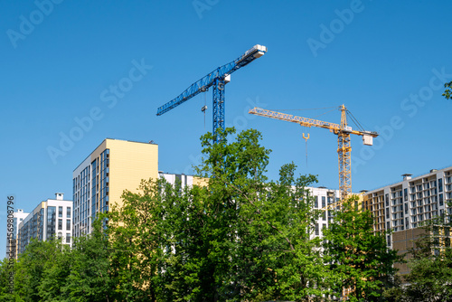 Voronezh, Russia, May 24, 2025: Construction of new high-rise buildings construction cranes in summer