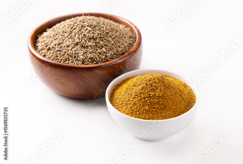 Fototapeta Naklejka Na Ścianę i Meble -  Indian food spice called cumin and cumin powder spice powder masala powder in wooden bowl isolated on white background