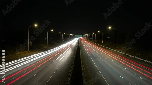 Nighttime highway with light trails and urban skyline