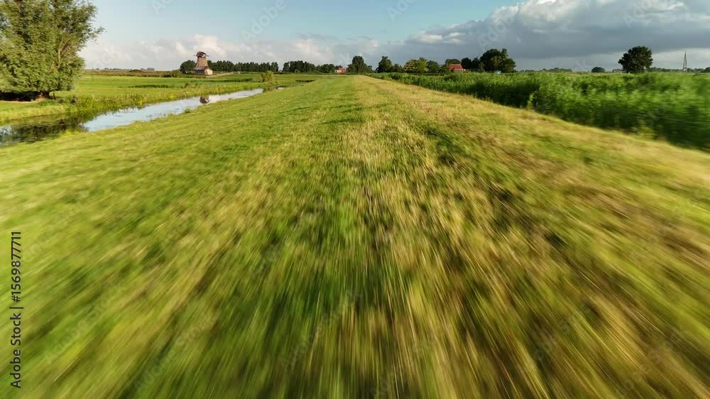 Fast drone flyover at low altitude above a green field in the Netherlands. Shot in 4K on July 2, 2025, featuring vibrant grass and rapid movement through rural landscape.