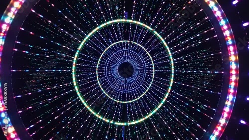 Abstract circular light tunnel with colorful led lights pulsing and moving fast