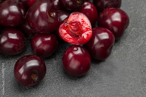 Heap of ripe cherries. Half cherry, pulp and  kernel of cherry