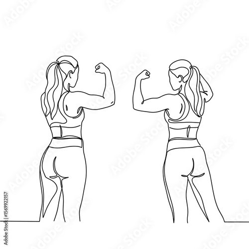 Two women flexing muscles in mirror while posing in fitness attire  
