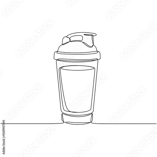 Clear blender cup with protein shake on a flat surface  