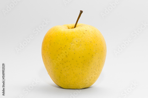 Yellow juicy apple on a white background. Summer fruits. Vitamins. Healthy food.
