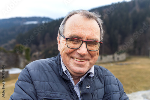 Mature caucasian male outdoors in nature smiling