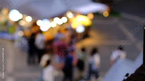 Wallpaper Mural A blurry photo of a group of people walking down a street. Scene is lively and bustling, with people of all ages and sizes moving about. The blurred effect gives the photo a sense of motion and energy Torontodigital.ca