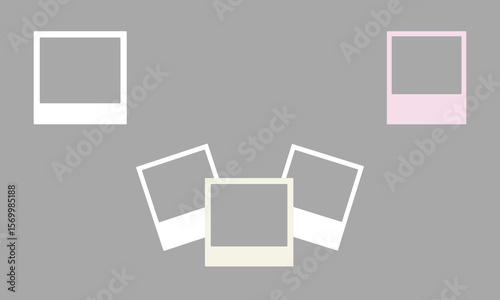 Four empty instant photo frames with white and pastel pink borders arranged on a plain grey background