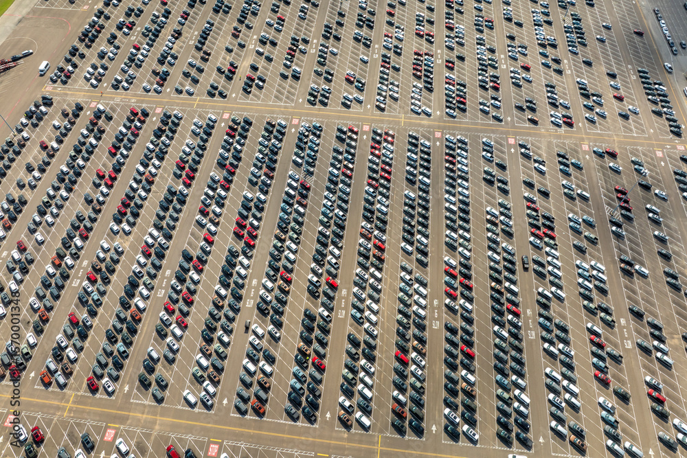 Obraz premium New cars parked on automotive factory parking lot for worldwide export. Dealer vehicle inventory business commercial