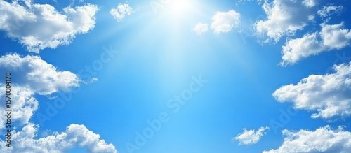 Radiant Summer Sky: A Breathtaking View of Blue Skies and Fluffy Clouds