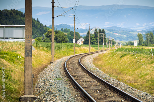 Railway tracks in Austria with Alps on background