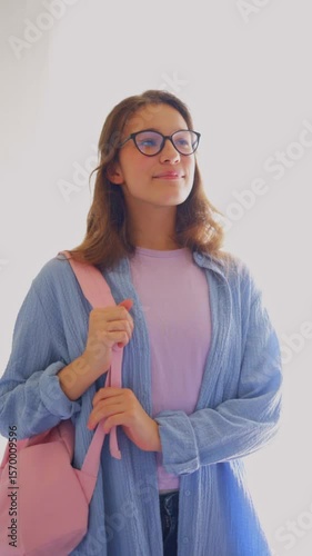 Young woman with glasses showing academic determination and self-assurance. Ideal for university promotions and scholarly narratives