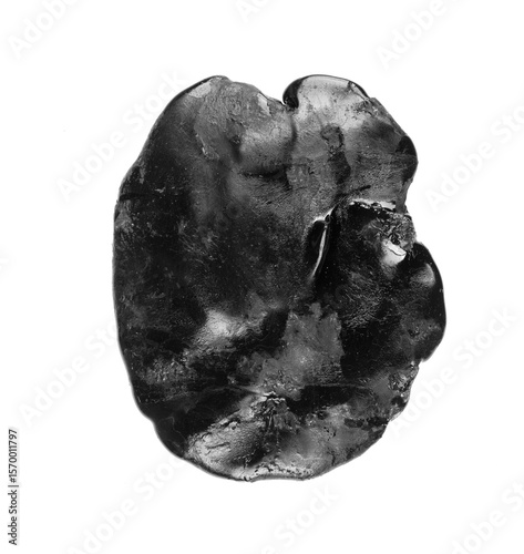 black shiny piece of construction bitumen isolated on white background