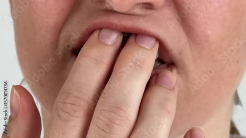 A woman uses chewing tobacco. 