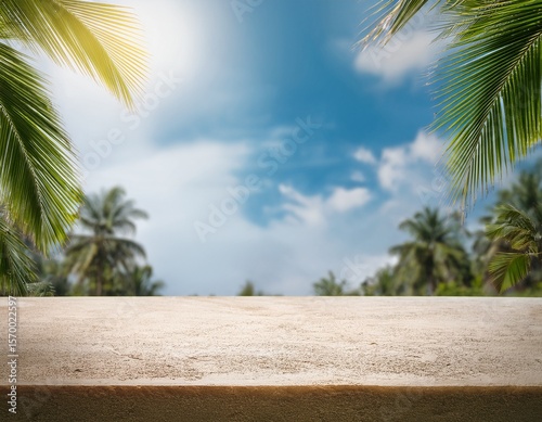 beige tabletop in jungle on sky background for product presentation concrete empty countertop with palm trees display case for beauty and drinks advertising