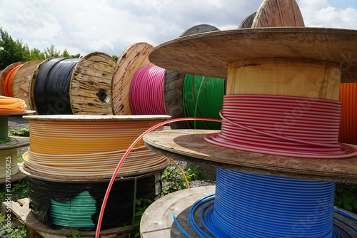 Big Rolls with colorful cable drums, fiber optic cables for faster Internet in rural region of Germany. City of Garbsen, district Hanover, Germany.