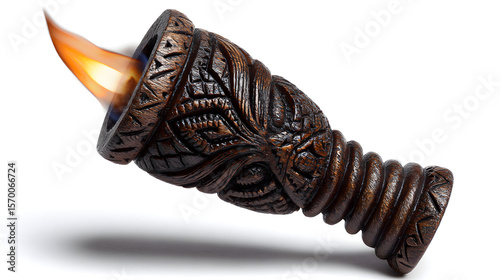Intricately carved wooden torch with a fiery flame burning brightly