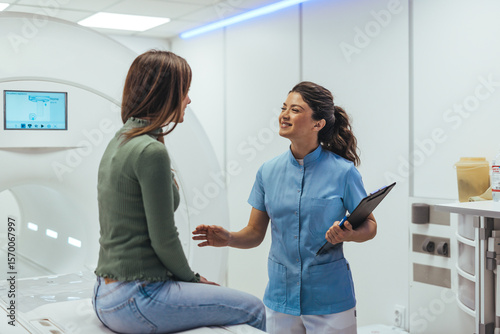 Female Technician Assisting Patient Inside Modern Medical Imaging Facility