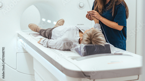 Photos Medical Technician Assists Patient During MRI Scan Procedure in a Hospital