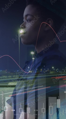 Animation of graph processing data over african american businesswoman in office and city at night