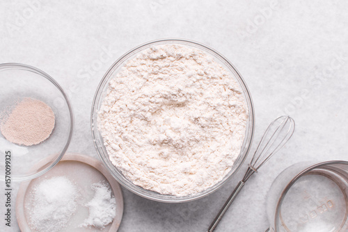 Mise en place of ingredients for making bread, All purpose flour vital wheat gluten and yeast on a marble countertop, process of making bread