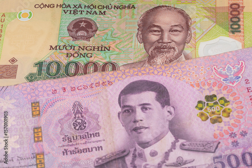 Wallpaper Mural 10000 Vietnamese dong and 500 Thai baht banknotes. International trade concept Torontodigital.ca