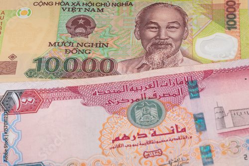 Wallpaper Mural 10000 Vietnamese dong and 100 United Arab Emirates dirham banknotes. International trade concept Torontodigital.ca