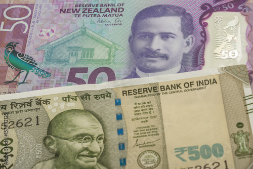 50 New Zealand dollar and 500 Indian rupee banknotes. International trade concept