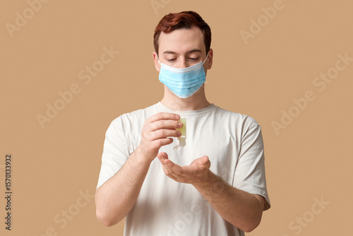 Young man with sanitizer on...