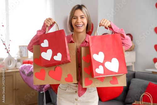 Happy young woman holding v...