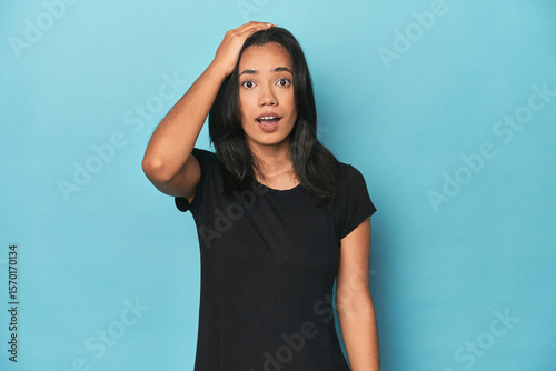 Bild auf Leinwand Filipina young woman on blue studio being shocked, she has remembered important meeting