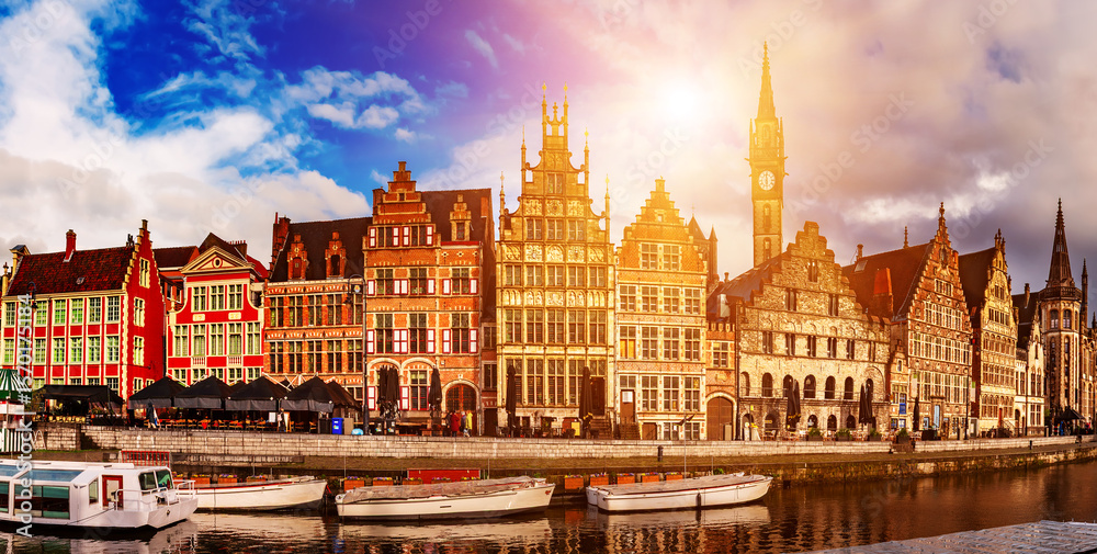 Obraz premium Ghent city historical center, tourists boats and colorful buildings on Leie river bank, Belgium