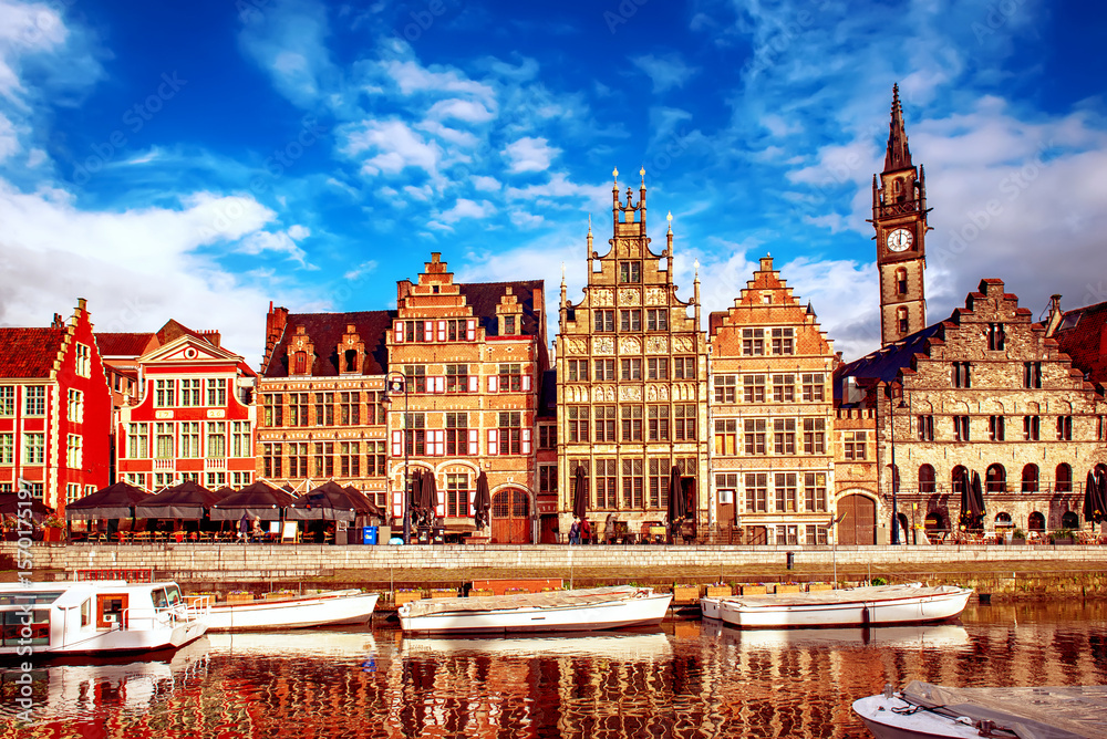 Obraz premium Ghent city historical center, tourists boats and colorful buildings on Leie river bank, Belgium