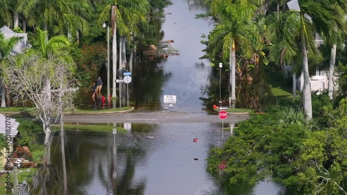 Hurricane Milton aftermath in Punta Gorda, Florida. City street closed because of flooding with warning signs blocking driving of cars.