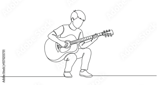 Young man playing acoustic guitar while squatting and smiling  