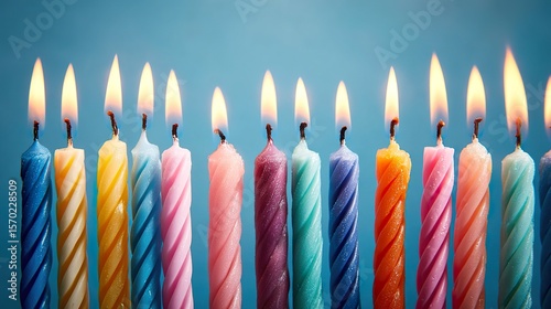 Colorful Birthday Candle Row, Isolated on Blue Background with Soft Overhead Lighting, 45-Degree birds-eye View
