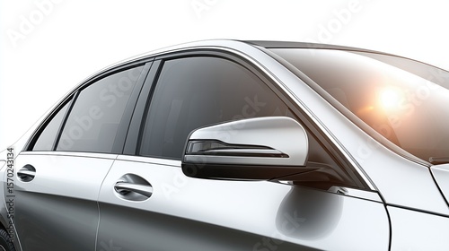 Car window with tinting reflecting sunlight on metallic finish  