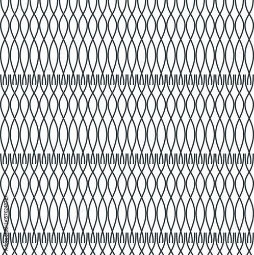 The lattice or fence consists of vertical wavy elements that intersect symmetrically with each other.