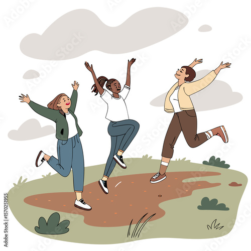 Three diverse young women joyfully jumping and celebrating together outdoors with arms raised in a park setting with clouds above