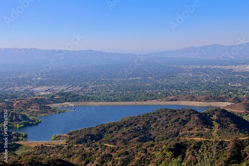 The Hollywood Hills fade into the San Fernando Valley with the San Gabriel Mountains and Santa Susana Mountains in the background and the Encino Reservoir in the foreground photo