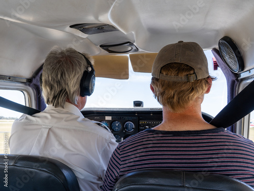 Pilot and student inside cockpit of small aircraft in flight training