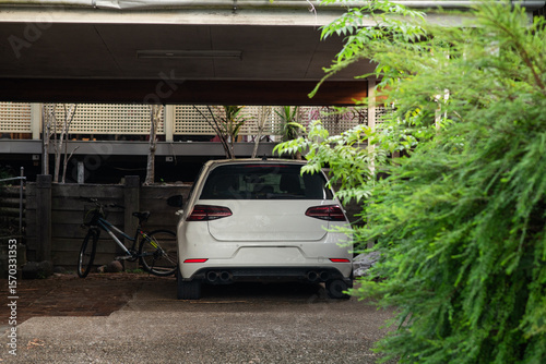 hatchback white car  parked in a carport