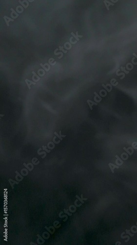 Slow motion of white smoke, fog, mist, vapor on a black background.