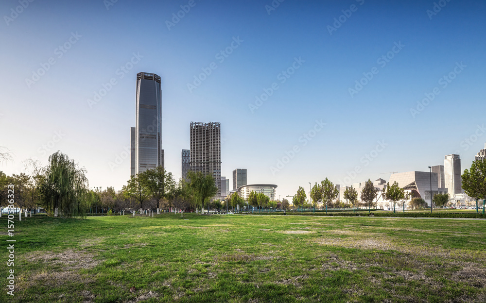 Tranquil Urban Park with Majestic Skyline Under Clear Blue Skies Tranquil Urban Park with Majestic Skyline Under Clear Blue Skies