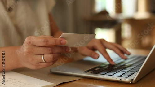 slow motion scene woman use laptop for choose item or beauty stuff from online shopping in web store and make payment by use credit card in living room for trendy lifestyle people concept