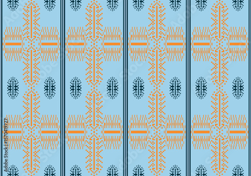 A pixelated textile design with yellow cross motifs and dark teal ovals on a sky-blue background. The structured layout and symmetry highlight a blend of traditional and modern textile inspiration.