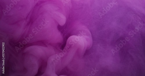 Purple splash. Glitter paint. Blur lilac color water swirling fluid ethereal vapor acrylic liquid floating on abstract background.